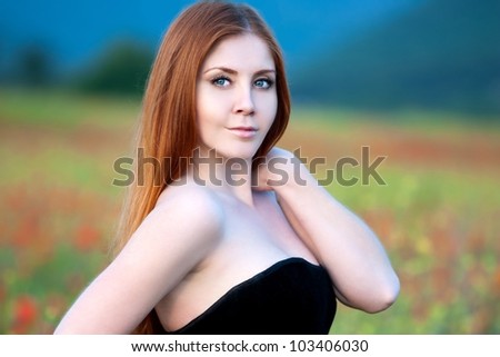 beautiful girl in a field of poppies