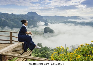 Beautiful girl with flower and fog on the mountain,View of mountains, winter landscape with foggy hills at sunrise. - Shutterstock ID 641650771