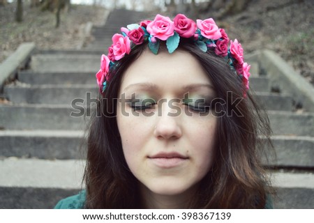 beautiful girl in a flower wreath made of polymer clay.hairpin in the shape of a flower on the hair of a young woman