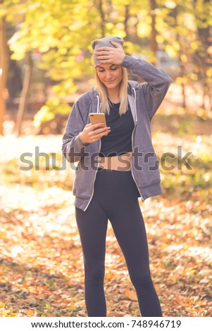 a beautiful girl in the forest reads the message and clings to her head
