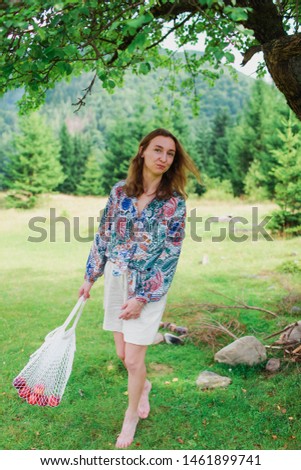 beautiful girl with fruit 
Caucasian Young girl Summer landscape and girl
