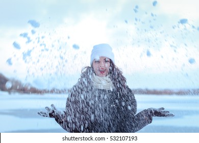 Beautiful Girl Fun Outdoor In Winter Forest Under Snowflakes.Pretty Young Model On Blue Background Holding A Snow. Winter Scene People Magic.