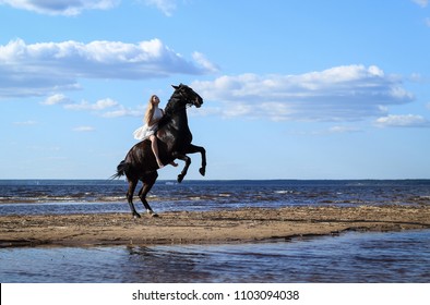 Golden-Haired beauty riding at the beach