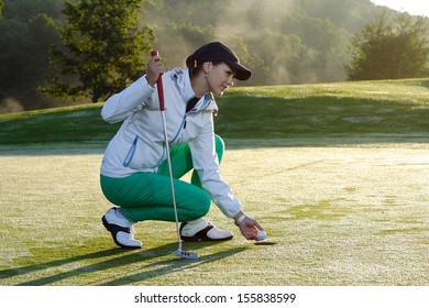 Beautiful girl golf player on field.