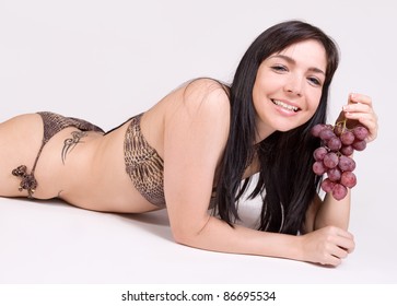 Beautiful girl with grapes
