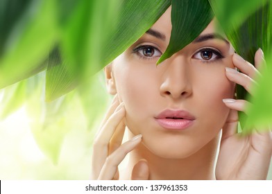 beautiful girl and green leaves
