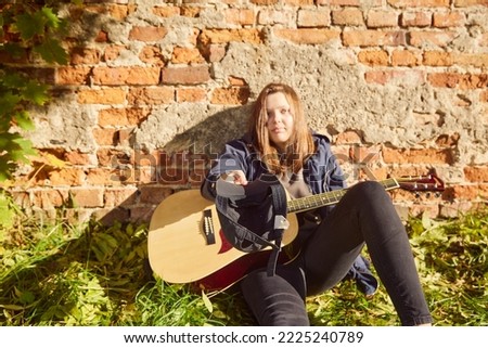 beautiful girl with guitar outdoor