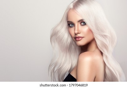 Beautiful girl with hair coloring in ultra blond. Stylish hairstyle curls done in a beauty salon. Fashion, cosmetics and makeup - Shutterstock ID 1797046819
