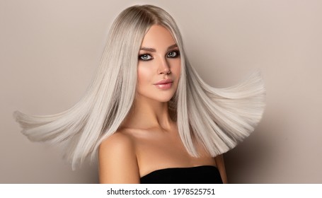 Beautiful Girl With Hair Coloring In Ultra Blond. Stylish Hairstyle Done In A Beauty Salon. Fashion, Cosmetics And Makeup
