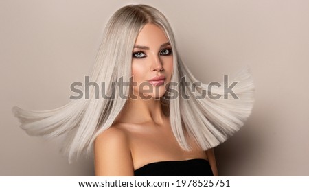 Beautiful girl with hair coloring in ultra blond. Stylish hairstyle done in a beauty salon. Fashion, cosmetics and makeup

