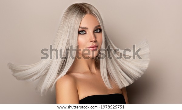 Beautiful\
girl with hair coloring in ultra blond. Stylish hairstyle done in a\
beauty salon. Fashion, cosmetics and\
makeup\
