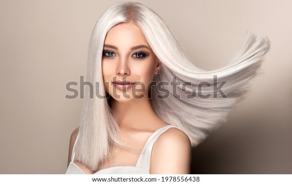 Beautiful\
girl with hair coloring in ultra blond. Stylish hairstyle done in a\
beauty salon. Fashion, cosmetics and\
makeup