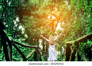 Beautiful girl happy fresh Among the nature of green forest,relaxing and feeling alive concept