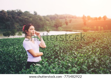 Beautiful girl happy in the tea plantation.
