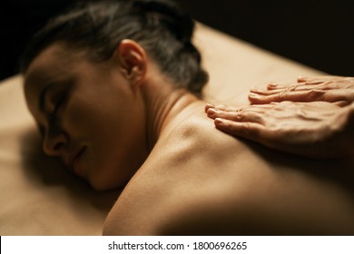 The Beautiful Girl Has Massage. Authentic Image Of Luxury Spa Treatment. Warm Colors, Charming Light.