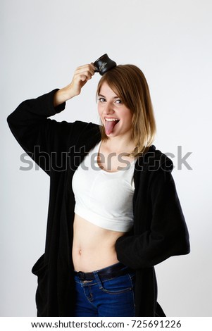 beautiful girl has put a cup of coffee on her head, in the studio on a white background