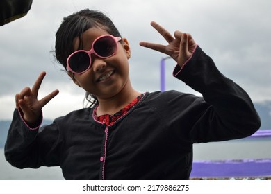 Beautiful Girl Having Fun With Closed Eyes Showing A Big Grin