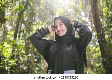 beautiful girl in hijab and black jacket getting ready to start a trip to the forest - Powered by Shutterstock