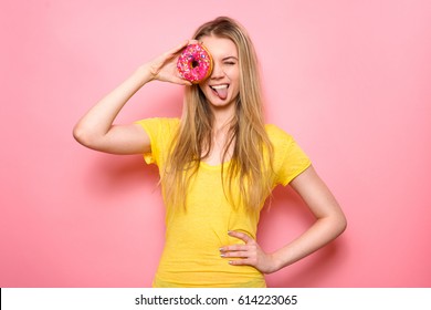 Beautiful Girl Holding Donut An Having Fun Isolated On Pink Background. People With Sweets.