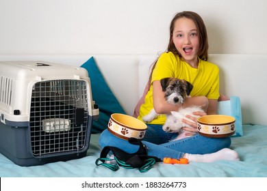 Beautiful Girl Holding A Puppy Of Jack Russell Terrier. Girl In A Yellow T-shirt With A Puppy On A White Background. Dog Care Items