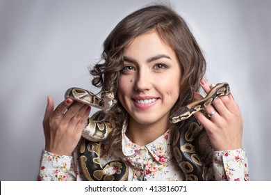 Beautiful Girl Holding Two Snakes