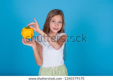 beautiful girl holding a yellow pepper fresh