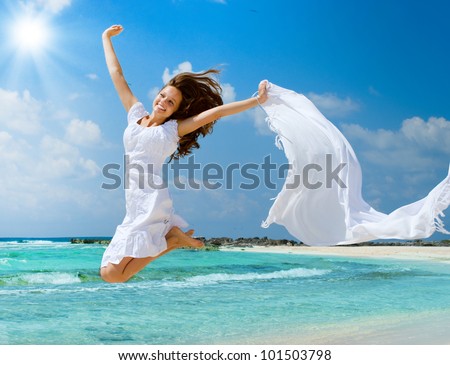 Beautiful Girl Jumping on The Beach. Vacation Concept