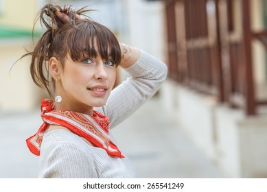 Beautiful Girl With Kerchief On Neck Against Wooden Handrail.