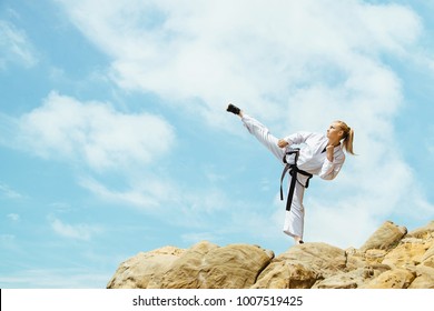 Beautiful girl in kimono stands on stones against the blue sky - Powered by Shutterstock