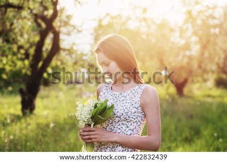 beautiful girl with lily of the valley