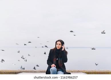 Beautiful Girl Listening To Music On Headphones On A Nature Background. Enjoy Your Favorite Song. Copy Space.