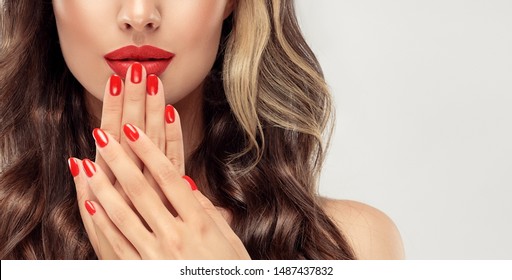 Beautiful Girl  Long , Curly Hair . Model Woman Showing A Red   Manicure On Nails   . Cosmetics And Makeup