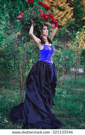 beautiful girl in a long dress in the garden