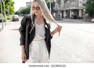 A Beautiful Girl With Long Even Hair Walks Around The City, The Model Is Wearing A Black Braid And White Trousers