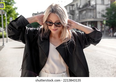 A Beautiful Girl With Long Even Hair Walks Around The City, The Model Is Wearing A Black Braid And White Trousers