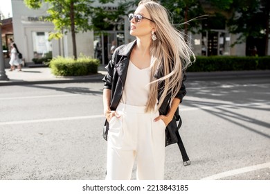 A Beautiful Girl With Long Even Hair Walks Around The City, The Model Is Wearing A Black Braid And White Trousers