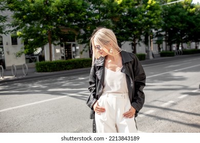 A Beautiful Girl With Long Even Hair Walks Around The City, The Model Is Wearing A Black Braid And White Trousers