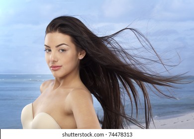 Beautiful Girl With A Long Hair On The Beach