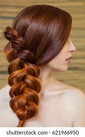 Beautiful Girl With Long Red Hair, Braided With A French Braid, In A Beauty Salon. Professional Hair Care And Creating Hairstyles.