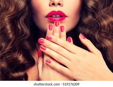 Beautiful Girl  Long , Thick Curly Hair . Model Showing A Pink  Manicure On Nails And Lips  .