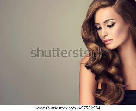 Beautiful girl with long wavy  and shiny  hair . Brunette woman  with curly hairstyle  ストックフォト © 