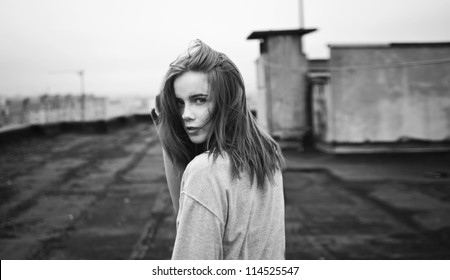 Beautiful Girl Looking Back On The Roof