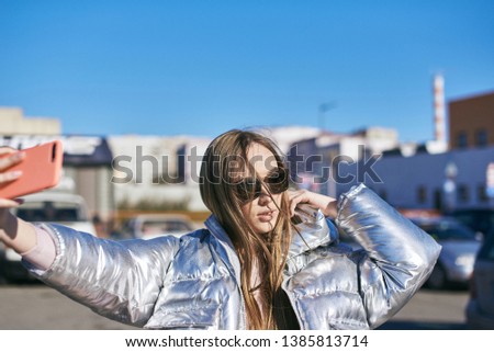 Similar – Young blonde woman in a sunny day in the city