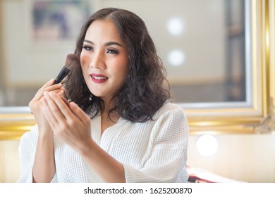 Beautiful girl makeup with her cosmetics. - Shutterstock ID 1625200870