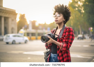 Beautiful girl making picture in a city - Powered by Shutterstock