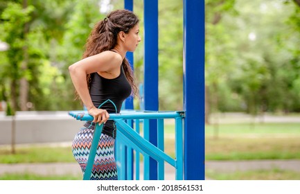 Beautiful Girl Making Push Ups At Stadium During Arm Workout. Young Sport Woman Exercising Outdoors