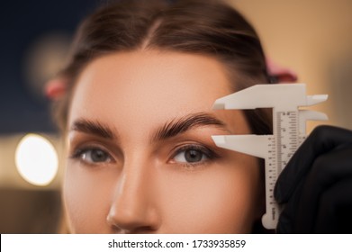 Beautiful girl master eyebrow posing in a beauty salon with laminated eyebrows and natural make-up. - Shutterstock ID 1733935859