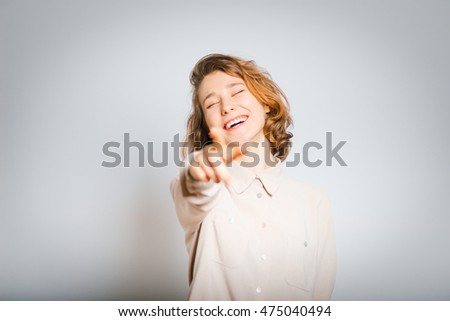 beautiful girl mocking of you, close-up, isolated on a gray background