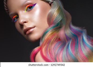 Beautiful girl and multi  colored hair   creative make  up   hairstyle  Beauty face  Photo taken in the studio