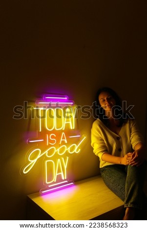 Beautiful girl with neon signs. Colorful neon sign today is a good day. Trendy style.  Neon sign. Custom neon. Home and party decor.